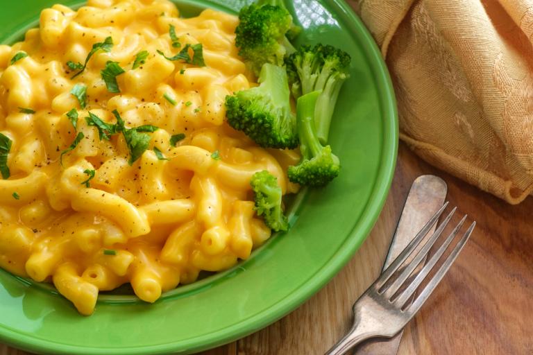 a plate of cheesy macaroni with broccoli